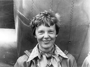Amelia_Earhart_standing_under_nose_of_her_Lockheed_Model_10-E_Electra